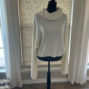Cozy Cream Turtleneck Sweater with oversized sleeves perfect for rolling.